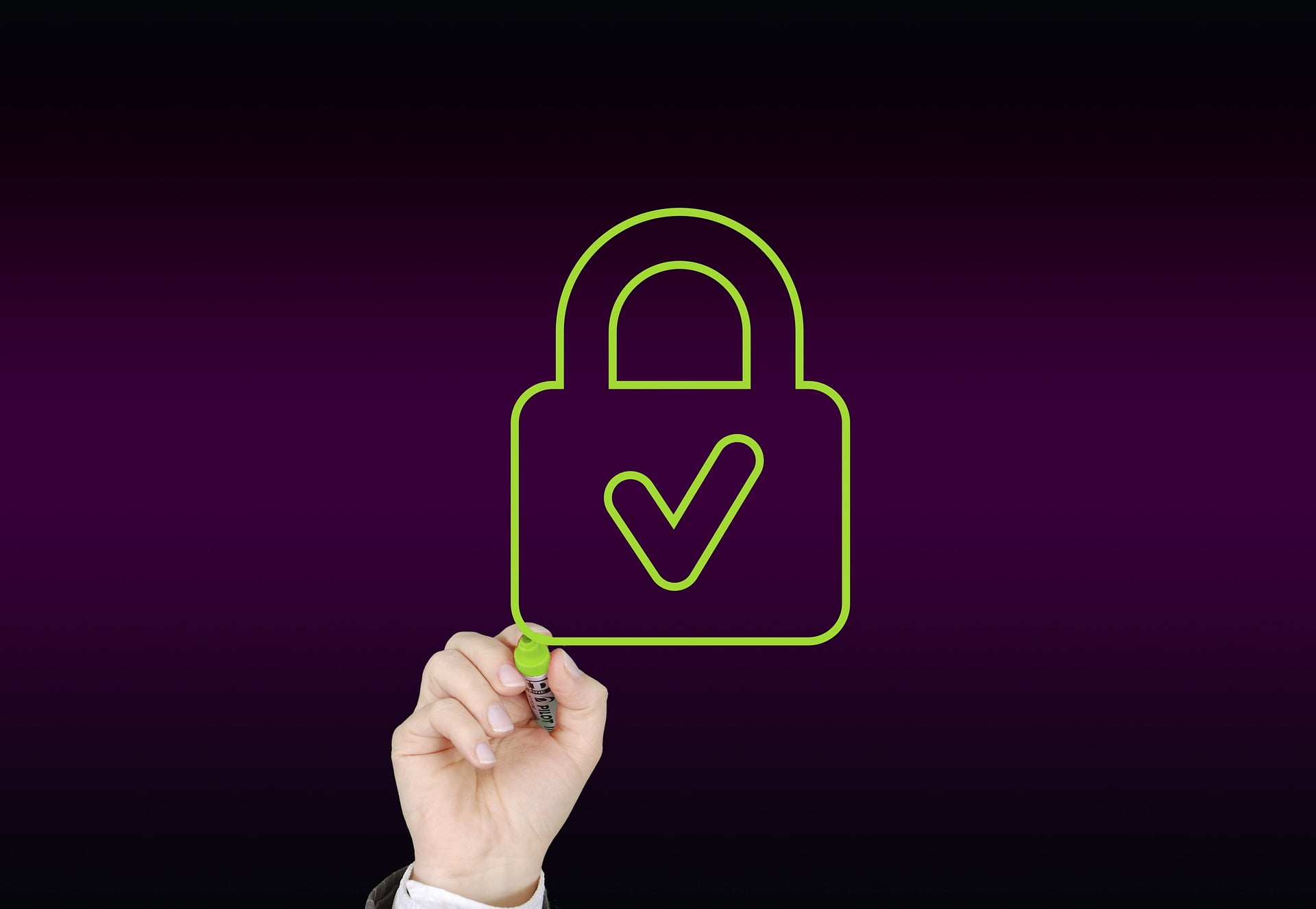 outline of a lock with a checkmark, a hand holding a pen next to the lock's lower left-hand corner.